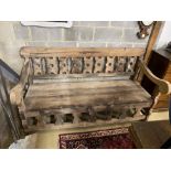 A carved hardwood settle from reclaimed boat timbers, length 191cm, depth 83cm, height 107cm