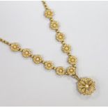 An Edwardian yellow metal and seed pearl set pendant brooch necklace, with flower head motifs, 43cm,