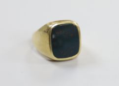 A mid 20th century 585 yellow metal and bloodstone set signet ring, size T, gross weight 10.6