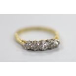 An 18ct, plat and graduated five stone diamond set half hoop ring, size M, gross weight 2.6 grams.