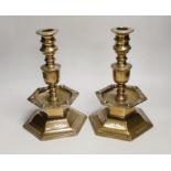 A pair of Scandinavian, possibly 17th century, brass candlesticks, dated 1644, each with a shield