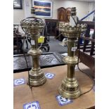 A pair of ecclesiastical style brass candlesticks converted to electricity, height 48cm