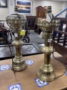 A pair of ecclesiastical style brass candlesticks converted to electricity, height 48cm