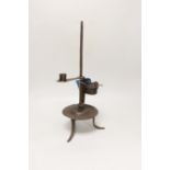 An 18th century Continental iron adjustable candle holder incorporating a crusie lamp, 41cm