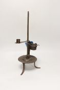 An 18th century Continental iron adjustable candle holder incorporating a crusie lamp, 41cm