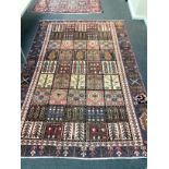 A Baktiari carpet woven panels of floral devices 280cm x 180cm