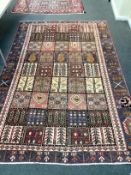 A Baktiari carpet woven panels of floral devices 280cm x 180cm