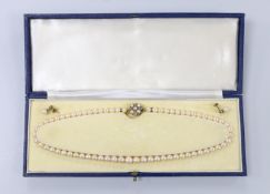 A single strand graduated cultured pearl necklace, with cultured pearl and diamond set yellow