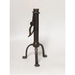 An 18th century rare iron candle holder, English, on tripod base, the cylindrical stem with push