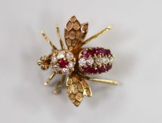 A 14k yellow metal, ruby and diamond cluster set bug brooch, 20mm, gross weight 3.1 grams.