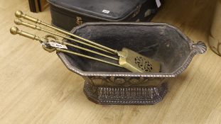 A cast iron log box and set of three brass fire-irons
