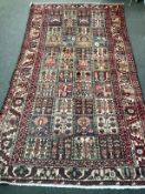 A Baktiari carpet woven panels of floral devices 300cm x 156cm