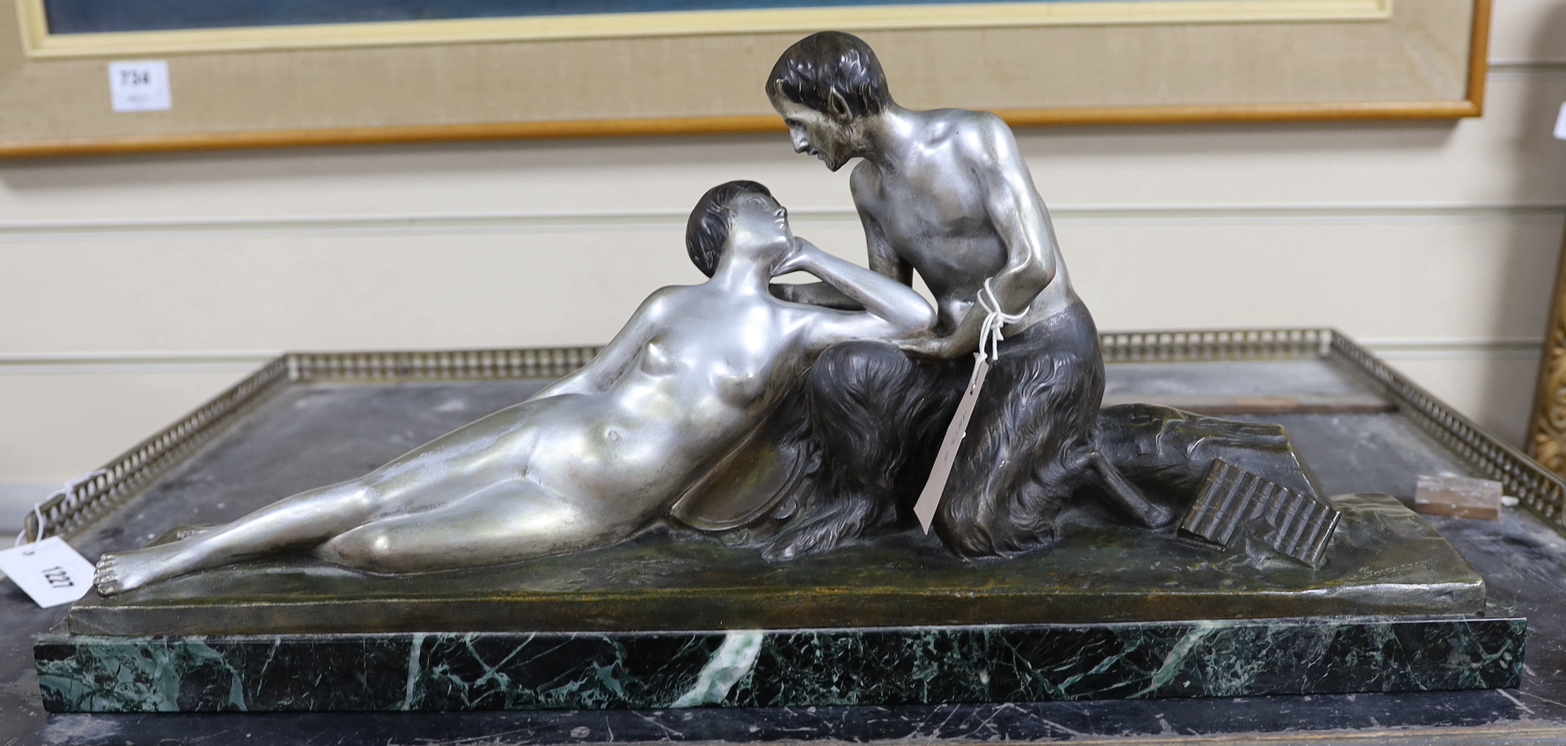 An Art Deco style bronze of a faun and his muse, signed H. Fonquergne, on marble base, 57cm