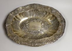 A large late 19th/early 20th century continental white metal oval bowl, embossed with birds, scrolls