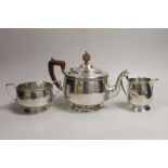 A George V silver circular three piece tea set, Alexander Clark Co, Birmingham, 1930, gross weight