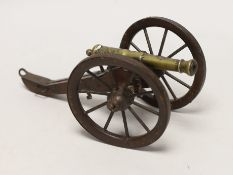 A 19th century model of an artillery gun, on wood carriage