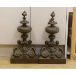 A pair of 19th century brass chenets, 50cm tall