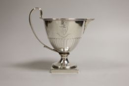 A George III demi-fluted vase shaped pedestal cream jug, Henry Chawner, London, 1791, height 13cm