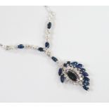 A modern 750 white metal, sapphire and diamond cluster set drop pendant necklace, overall 52cm,