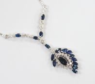 A modern 750 white metal, sapphire and diamond cluster set drop pendant necklace, overall 52cm,