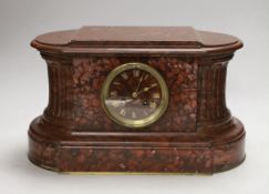 A French rouge marble eight day mantel clock, 38cm wide