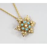 An Edwardian yellow metal, turquoise and seed pearl set flower head pendant brooch, overall 36mm, on