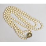 A twin strand cultured pearl necklace, with a cultured pearl and diamond chip set yellow metal