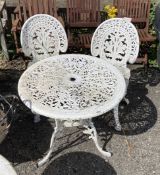 A Victorian style painted aluminium garden table, diameter 68cm, height 68cm, and a pair of chairs