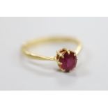 A 1960's 18ct gold and solitaire ruby set ring, size O, gross weight 2.2 grams.