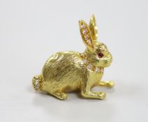 A modern 18ct yellow gold, diamond and ruby set novelty brooch, in the form of a seated hare, marked