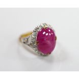 A yellow metal cabochon ruby and diamond chip set oval cluster ring, size M/N, gross weight 4.9