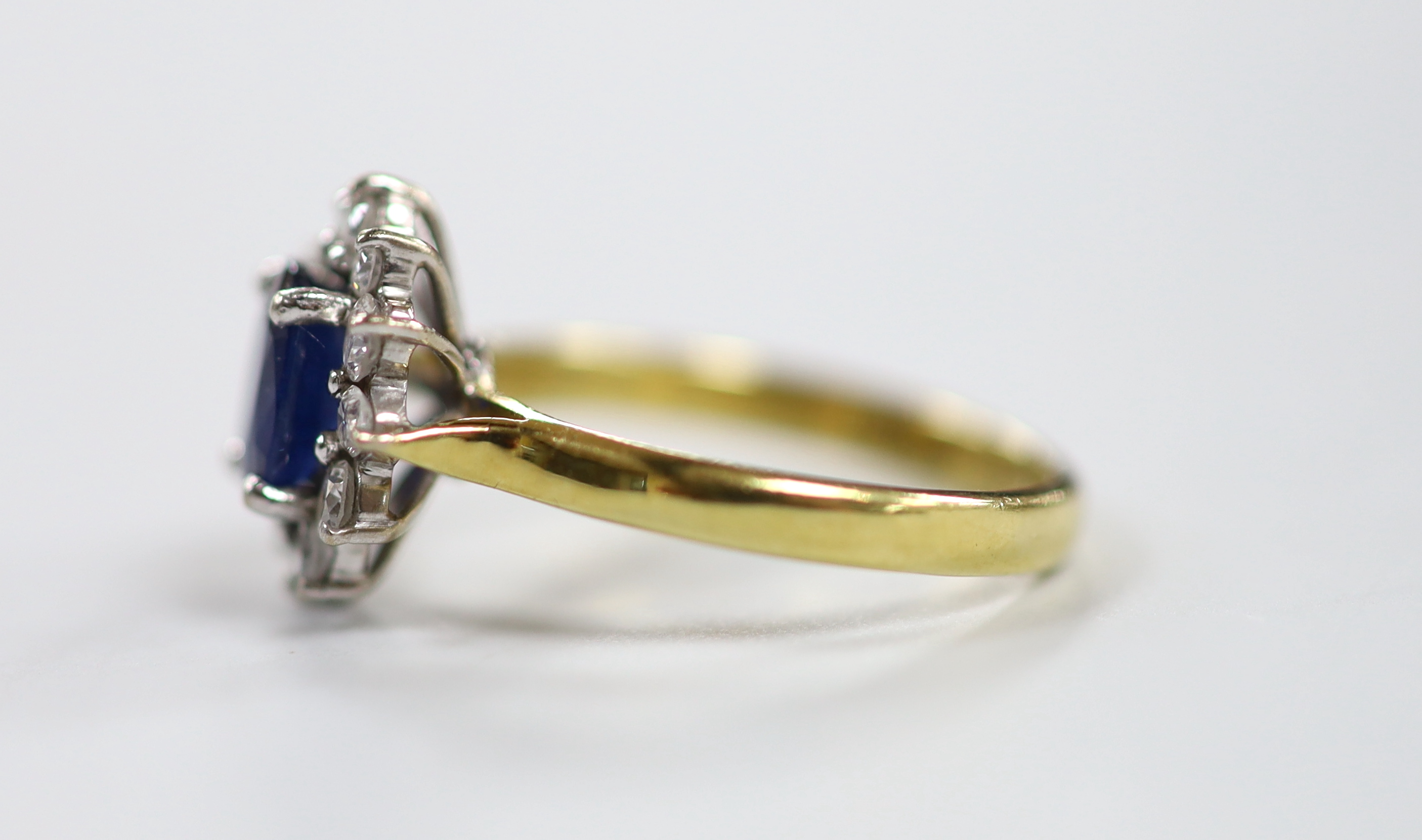 A modern 18ct gold sapphire and diamond set oval cluster ring, size J, gross weight 3.2 grams. - Image 2 of 3