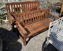 A pair of stained teak garden benches, width 152cm, height 93cm.
