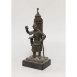 An early 20th century bronze figural match holder, on slate plinth, 20cm