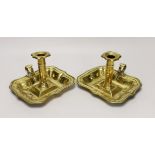 A pair of 18th century brass chamber candlesticks, the rectangular trays with wave edges, 18cm wide