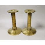 A pair of Arts and Crafts hammered brass candlesticks, with detachable sconces, 21cm