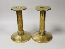 A pair of Arts and Crafts hammered brass candlesticks, with detachable sconces, 21cm