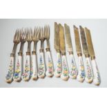 Six pairs of French Faience pistol grip handled knives and forks