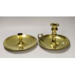 An 18th / 19th century brass saucer candlestick and an 18th century brass chamber candlestick, on