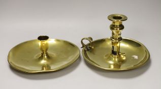 An 18th / 19th century brass saucer candlestick and an 18th century brass chamber candlestick, on