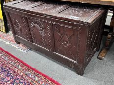 A 17th century later carved oak coffer, width 132cm