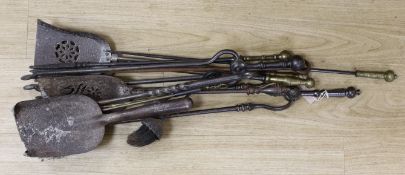 A large collection of 18th century and later wrought iron and brass tipped iron fire implements