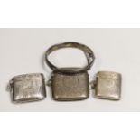 Three assorted late 19th/early 20th century chased silver vesta cases and a chased silver hinged