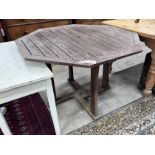 An octagonal teak garden table, width 111cm, height 75cm