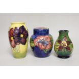 A Moorcroft hibiscus jar and cover, 16cm, an anemone vase and another