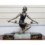 An Art Deco spelter figure of a lady on marble base, signed Arris?, 56cm wide