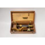 A lacquered brass field microscope, in fitted case, case 26cm wide
