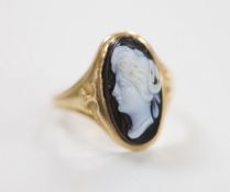 A late 19th century yellow metal and oval cameo set ring, carved with the bust of a lady to