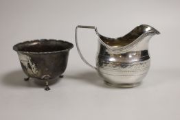 A George III chased silver cream jug, James Mince, London, 1809, 81mm and a later silver sugar bowl,
