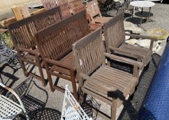 A pair of stained teak garden benches, width 121cm, height 99cm, and a pair of matching elbow